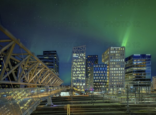 Barcode neighbourhood with acrobats pedestrian bridge night northern lights Oslo Norway