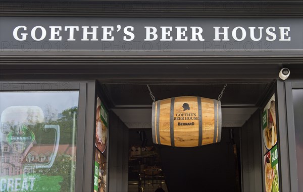 Beer barrel hanging above the entrance to Goethe's Bierhaus, Karlovy Vary, Bohemia, Czech Republic,