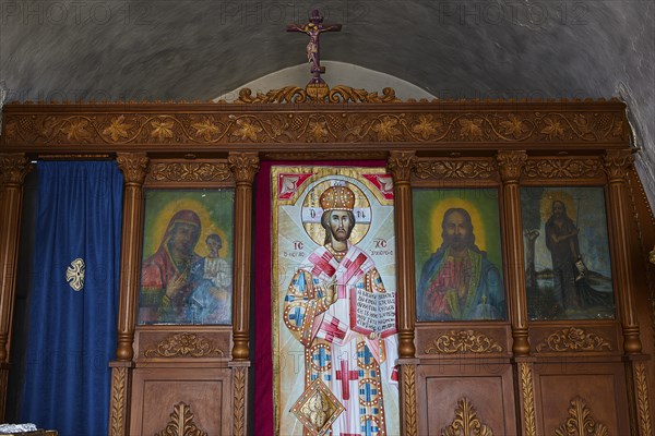 Interior with richly decorated iconostasis and religious images of saints, Kastro Monolithou,