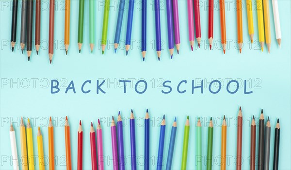 Color pencils collection in a row, back to school, drawing supplies, blue background with copy