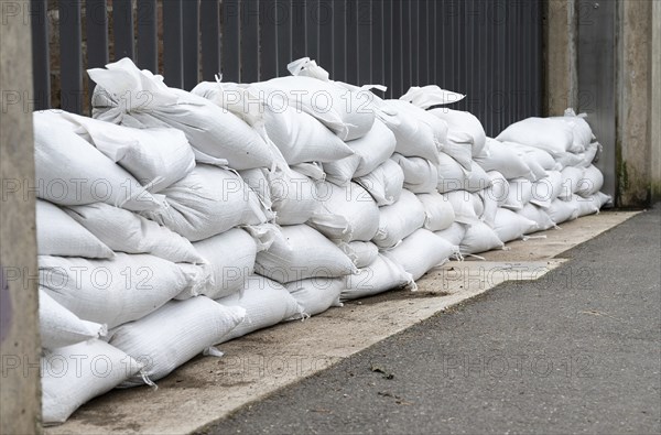 Sandbags for flood defense, river Moselle Trier in Rhineland Palatinate, flooded trees and paths,