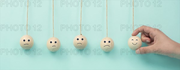 Happy smiling face spread happiness to sad faces, newton cradle concept, mental health and