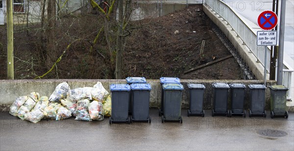 Pile of waste plastic trash bags and bins in Germany, garbage collection, environment and pollution