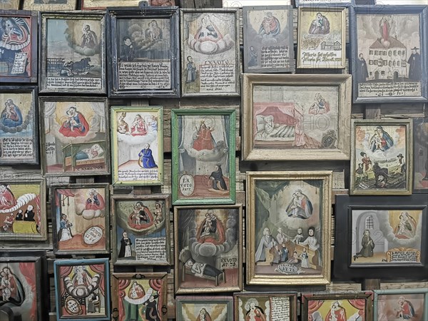 Votive pictures, votive tablets on the walls of the chapel of grace inside the church, pilgrimage