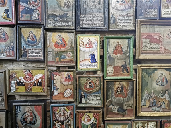 Votive pictures, votive tablets on the walls of the chapel of grace inside the church, pilgrimage
