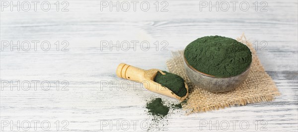 Spirulina algae powder in a bowl, alternative medicine for to detox, antioxidant food ingredients