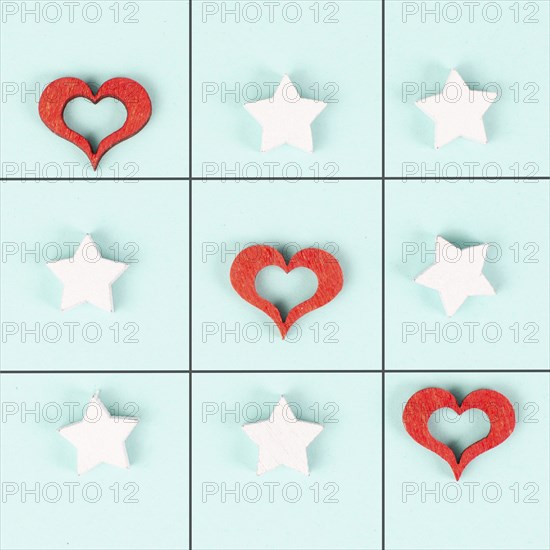 Tic tac toe game with red hearts and stars, symbol for love and emotion, valentines day