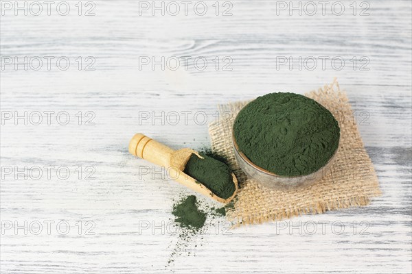 Spirulina algae powder in a bowl, alternative medicine for to detox, antioxidant food ingredients