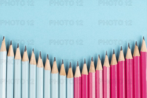 Blue and pink colored pencils building a row, copy space for text, back to school, education