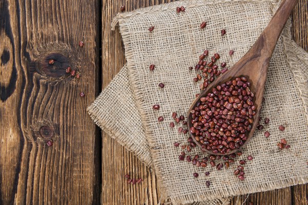Dried red beans on dark rustic wooden background