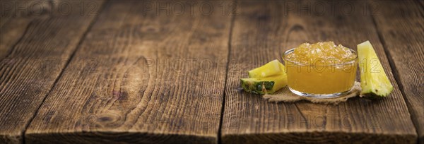 Fresh made Pineapple Jam on a vintage background as detailed close-up shot