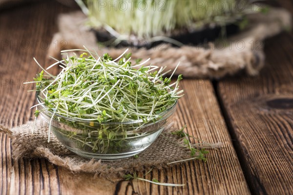 Fresh Cress (close-up shot) on rustic wooden background