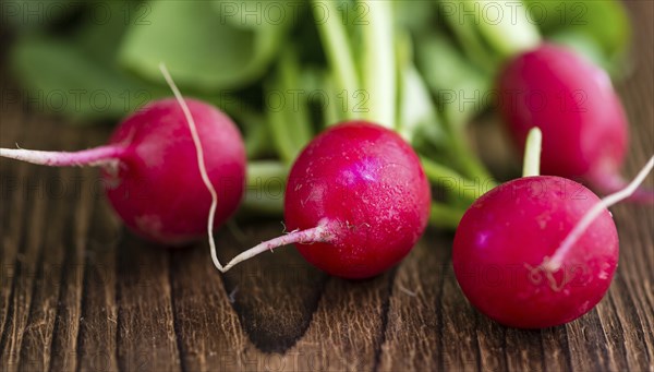 Fresh Radishes on wooden background (selective focus, close-up shot)