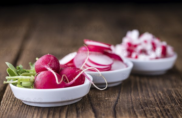 Radishes (whole, sliced and diced) as detailed close-up shot (selective focus)
