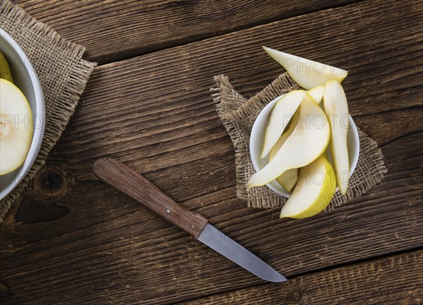 Pears (selective focus) on an old wooden table (close-up shot)