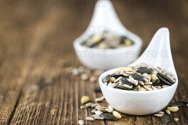 Mixed Seeds (close-up shot, selective focus) on vintage wooden background