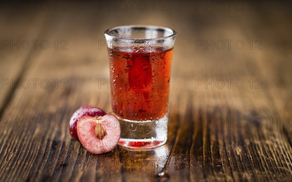 Homemade Cherry Liqueur on vintage background selective focus, close-up shot