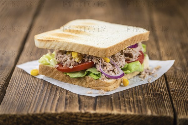 Homemade Tuna Sandwich (selective focus, close-up shot) on vintage wooden background