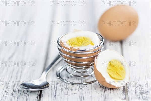 Some boiled Eggs (close-up shot, selective focus) on an old wooden table