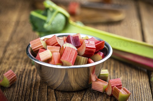 Chopped Rhubarb on an old wooden table (close up shot, selective focus)