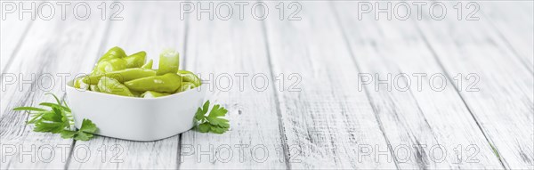 Fresh made Green Chilis (filled with cheese) on a vintage background (close-up shot)