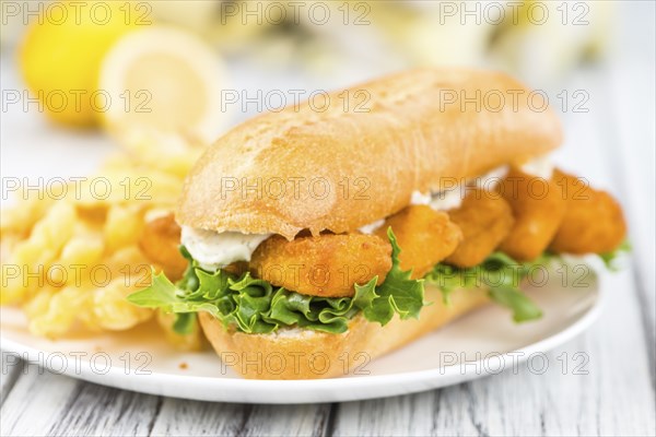 Fresh made Snack (Sandwich with Fish Sticks) on an old wooden table
