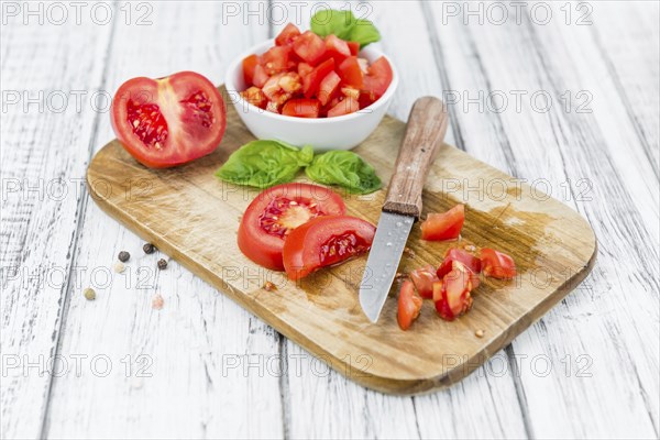 Diced Tomatoes on a vintage background as detailed close-up shot (selective focus)