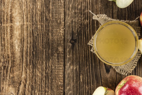 Wooden table with Applesauce (close-up shot, selective focus)
