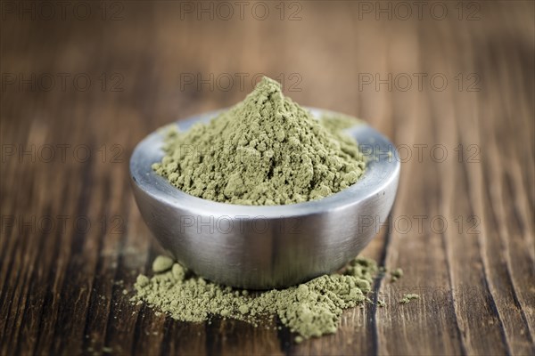 Stevia leaf powder (detailed close-up shot) on rustic wooden background