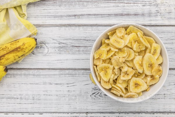 Portion of fresh Dried Banana Chips close-up shot, selective focus