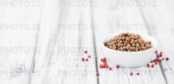 Portion of fresh preserved Pink Peppercorns close-up shot, selective focus