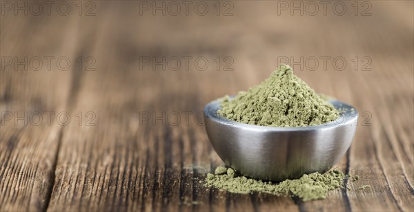 Stevia leaf powder (detailed close-up shot) on rustic wooden background