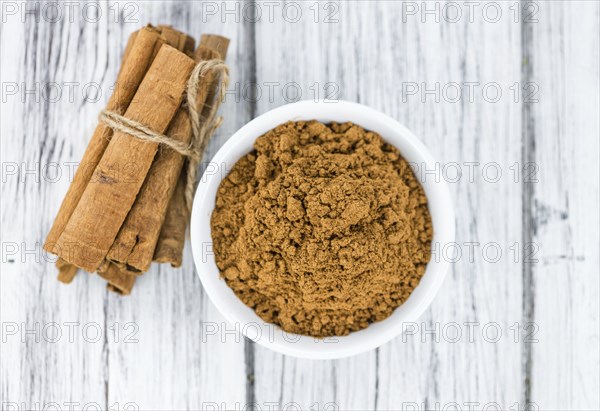 Fresh made Cinnamon Powder on a vintage background (close-up shot)