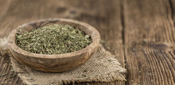 Portion of Stevia Leaves (dried, close-up shot) on wooden background