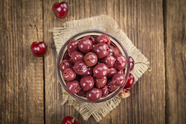 Fresh made Canned Cherries on a vintage background as detailed close-up shot