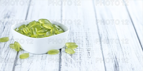 Gummy Candy with lime taste (selective focus) on wooden background