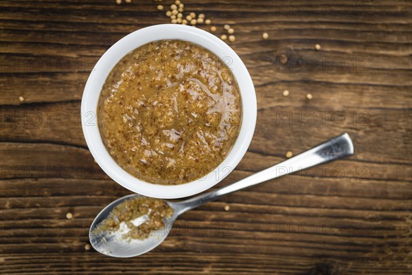 Fresh made German Cuisine (sweet Mustard) on a vintage background (close-up shot)