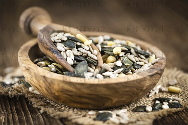 Mixed Seeds (close-up shot, selective focus) on vintage wooden background