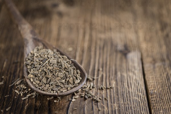 Dried Valerian roots (detailed close-up shot) on wooden background