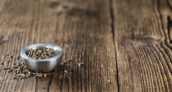 Valerian roots (dried, detailed close-up shot) on wooden background