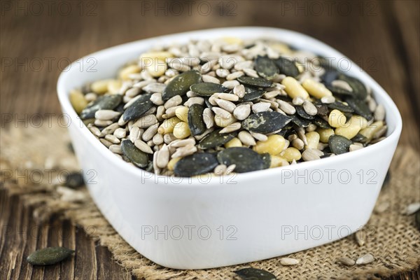 Heap of mixed Seeds (close-up shot) on wooden background