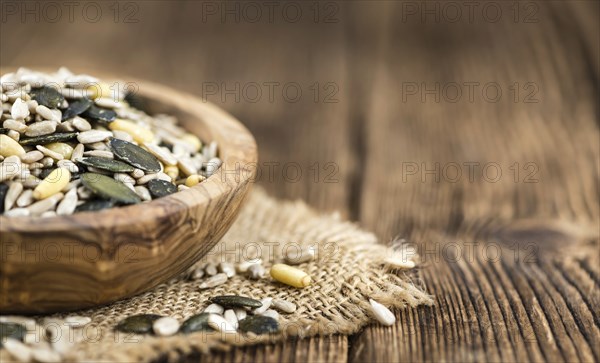 Mixed Seeds (close-up shot, selective focus) on vintage wooden background
