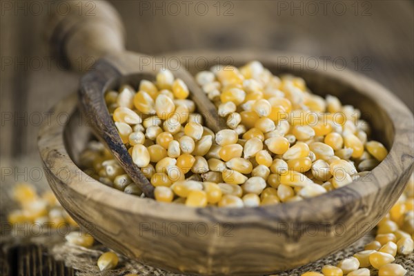 Wooden table with a portion of Corn (selective focus, close-up shot)