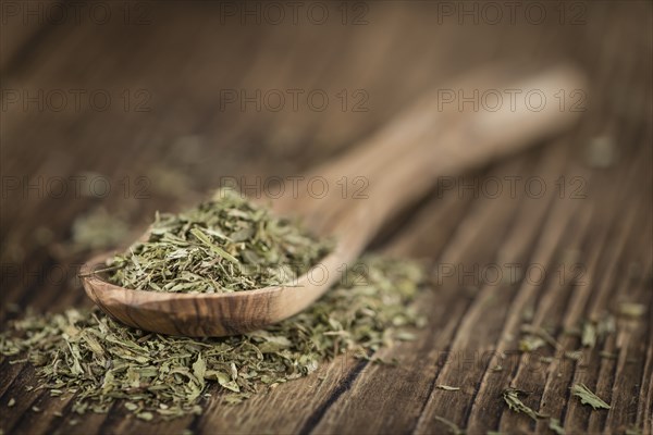 Portion of Stevia Leaves (dried, close-up shot) on wooden background