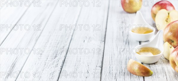 Wooden table with Applesauce (close-up shot, selective focus)