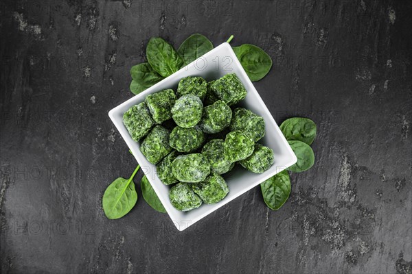 Frozen spinach cubes as detailed close up shot (selective focus)