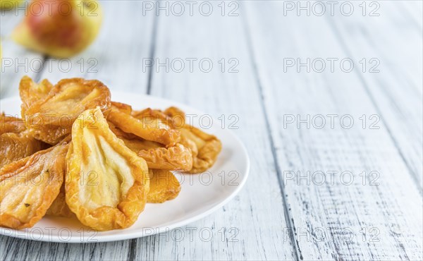 Some dried Pears (selective focus, close-up shot) on wooden background