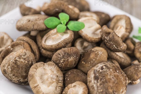 Portion of fresh Shiitake mushrooms close-up shot, selective focus