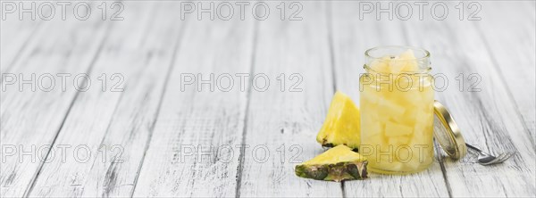 Preserved Pineapple pieces on a vintage background as detailed close-up shot, selective focus