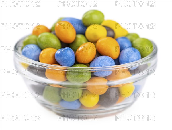 Chocolate coated peanuts isolated on white background (selective focus)
